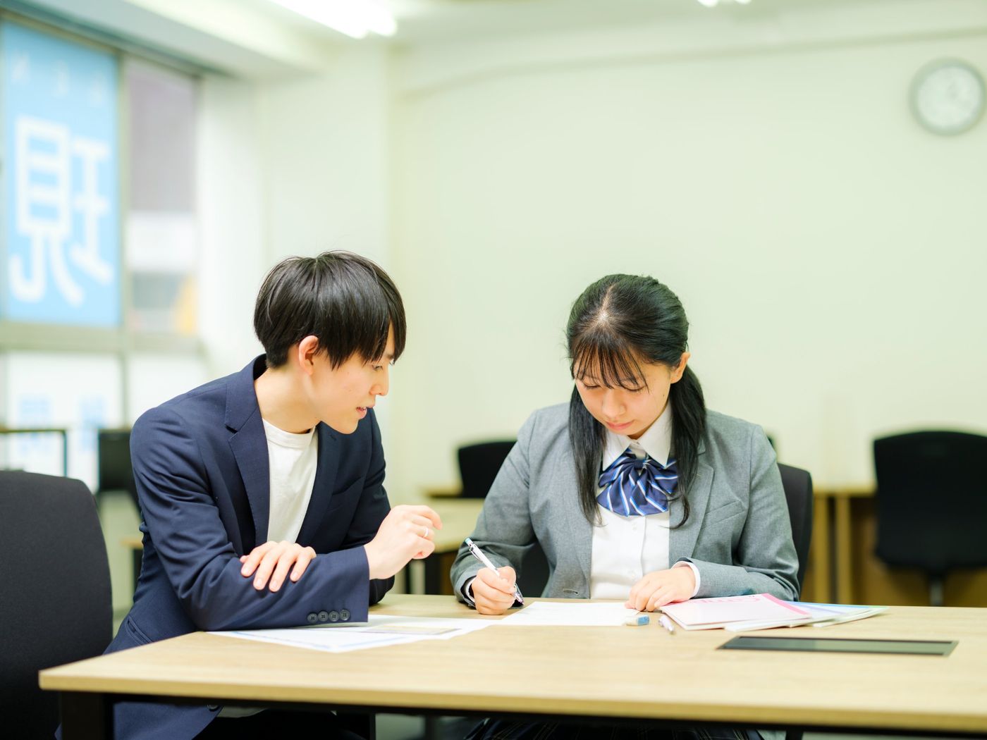 講師が生徒の答案を見ながら指導している様子